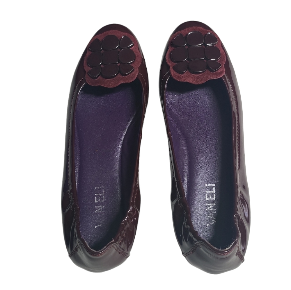 Van Eli Patent leather flat shoes with front appliqué.